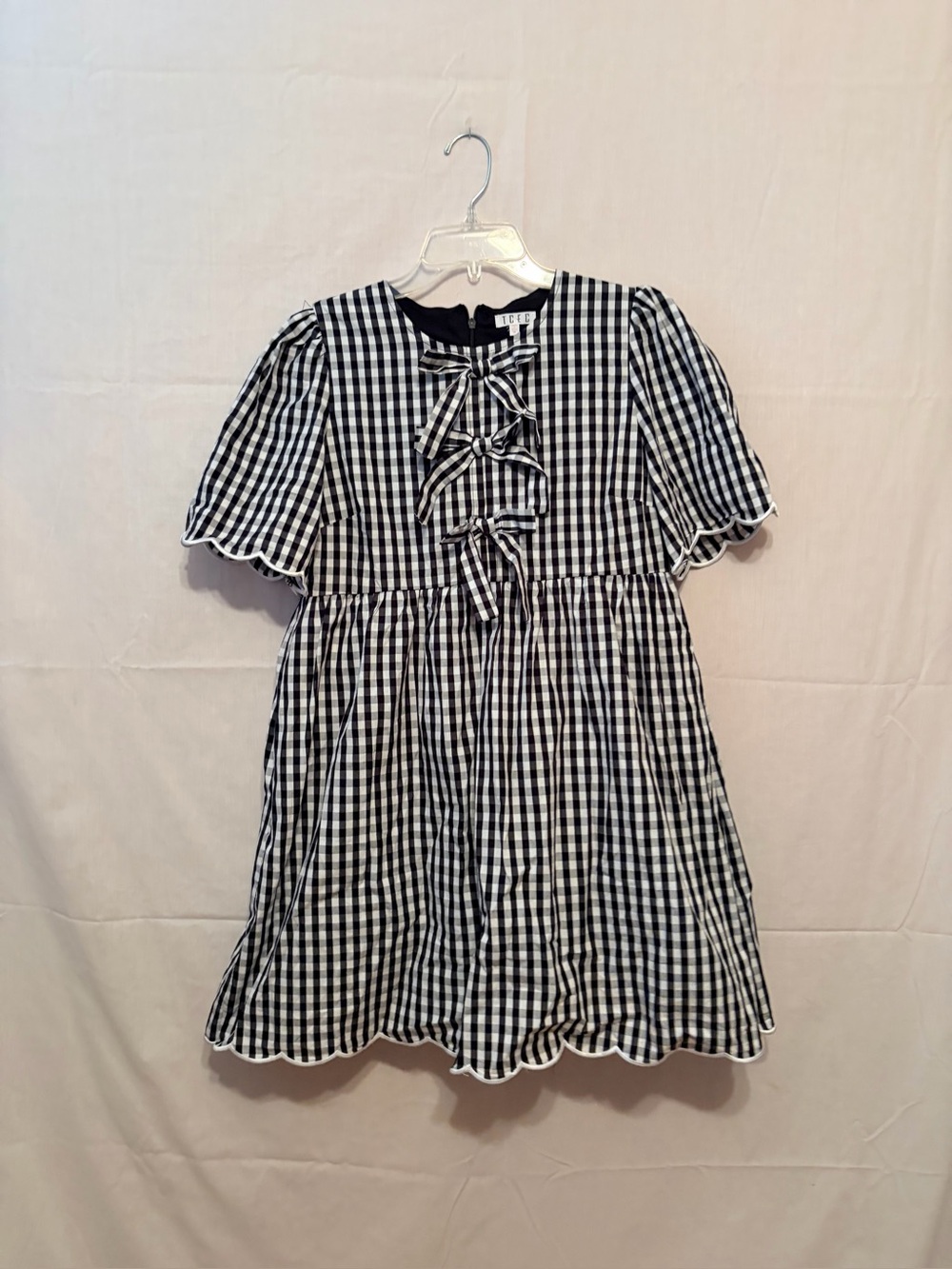 Saucy Boutique mini dress  a black and white gingham print front tie closures